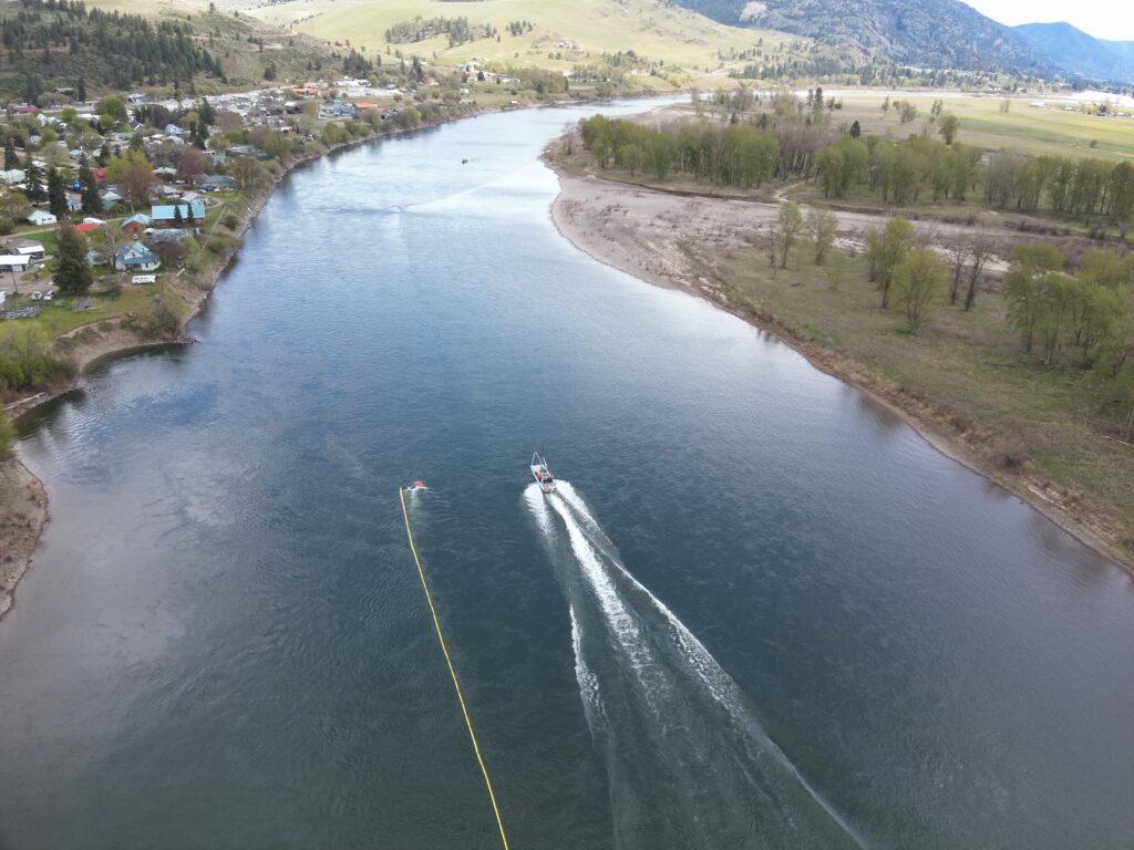 Drone photo showing a boat traveling down a river